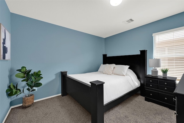 carpeted bedroom featuring visible vents and baseboards