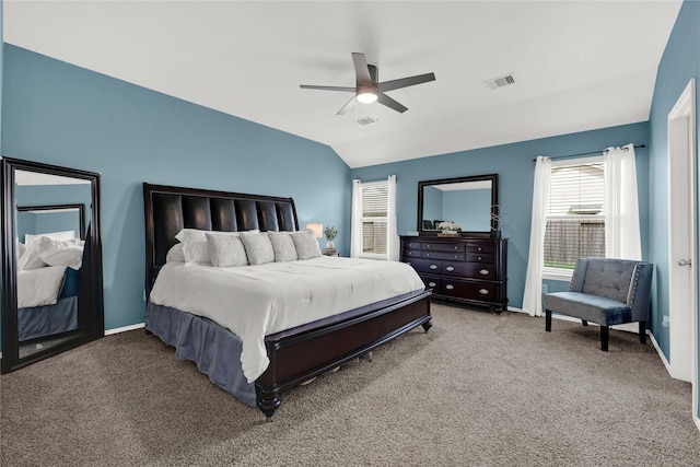 carpeted bedroom with visible vents, a ceiling fan, baseboards, and vaulted ceiling