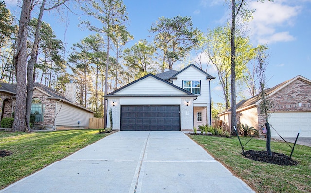 view of front of house with concrete driveway, fence, brick siding, a garage, and a front yard