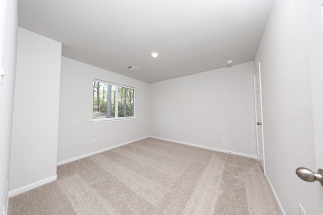 carpeted empty room with baseboards and visible vents