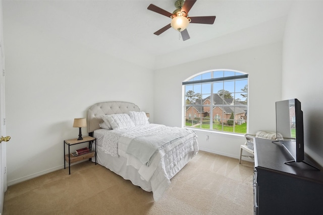 bedroom featuring a ceiling fan, baseboards, and light carpet