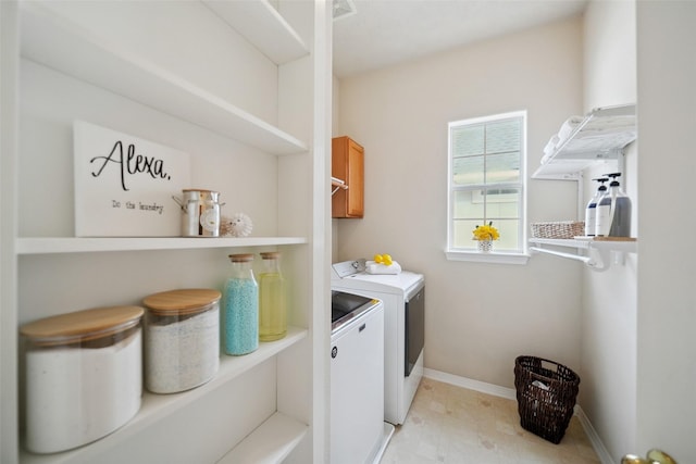 washroom with baseboards, cabinet space, independent washer and dryer, and visible vents