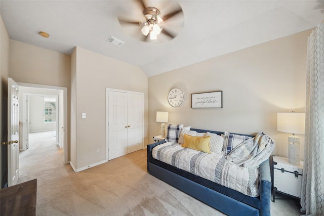 carpeted bedroom featuring baseboards, visible vents, ceiling fan, vaulted ceiling, and a closet