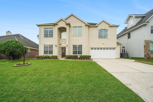 traditional-style house with an attached garage, a front lawn, concrete driveway, central air condition unit, and brick siding