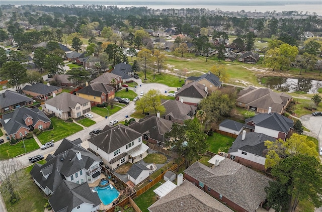 drone / aerial view with a residential view and a water view