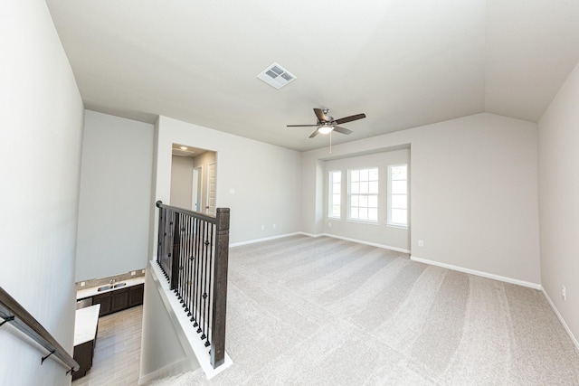 3714 Windswept Dr, Montgomery, TX 77356 - spare room featuring light carpet, baseboards, visible vents, lofted ceiling, and ceiling fan