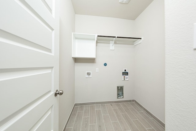 3714 Windswept Dr, Montgomery, TX 77356 - laundry room featuring hookup for an electric dryer, baseboards, washer hookup, wood finish floors, and laundry area