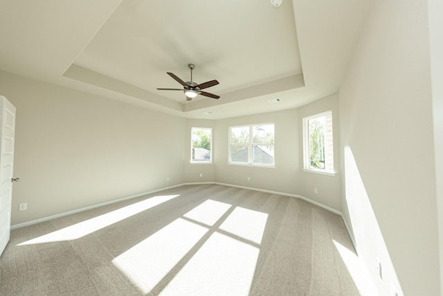 3714 Windswept Dr, Montgomery, TX 77356 - spare room with light carpet, visible vents, baseboards, ceiling fan, and a raised ceiling