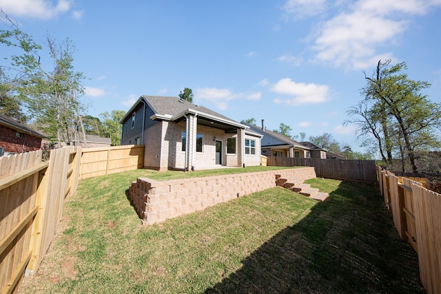 3714 Windswept Dr, Montgomery, TX 77356 - back of property featuring brick siding, a lawn, and a fenced backyard