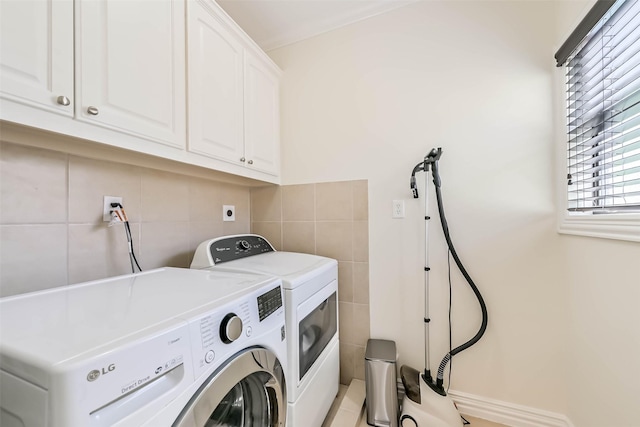 4303 Blossom St, Houston, TX 77007 - laundry room featuring cabinet space, washing machine and clothes dryer, and tile walls
