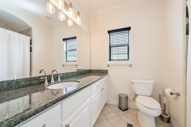 4303 Blossom St, Houston, TX 77007 - bathroom featuring vanity, toilet, ornamental molding, baseboards, and tile patterned flooring