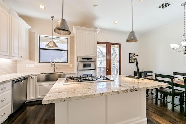 4303 Blossom St, Houston, TX 77007 - kitchen featuring a sink, stainless steel appliances, dark wood-style flooring, tasteful backsplash, and recessed lighting