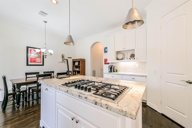 4303 Blossom St, Houston, TX 77007 - kitchen with stainless steel gas stovetop, arched walkways, dark wood-style floors, decorative backsplash, and recessed lighting