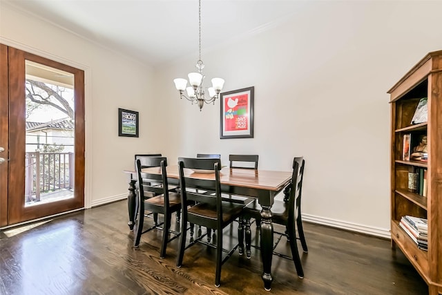 4303 Blossom St, Houston, TX 77007 - dining space featuring a chandelier, dark wood-style flooring, baseboards, and crown molding
