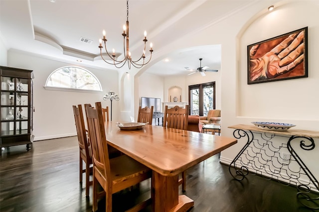 4303 Blossom St, Houston, TX 77007 - dining space featuring arched walkways, dark wood-style flooring, ceiling fan, a chandelier, and baseboards