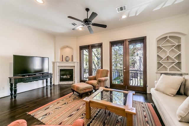 4303 Blossom St, Houston, TX 77007 - living area featuring crown molding, wood finished floors, ceiling fan, a high end fireplace, and french doors