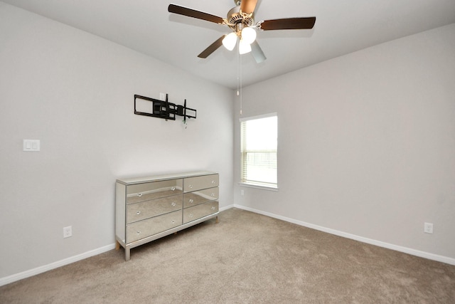 unfurnished room featuring carpet flooring, baseboards, and a ceiling fan