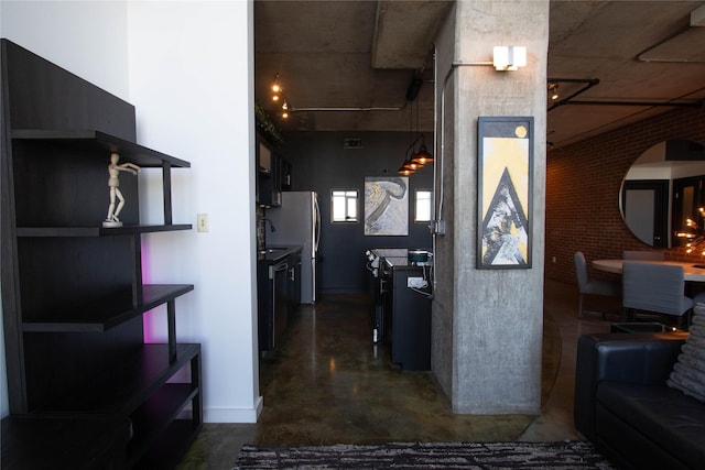 hall featuring concrete floors and a sink