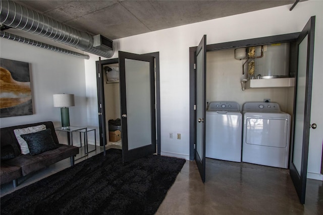 laundry area featuring baseboards, washing machine and dryer, and laundry area