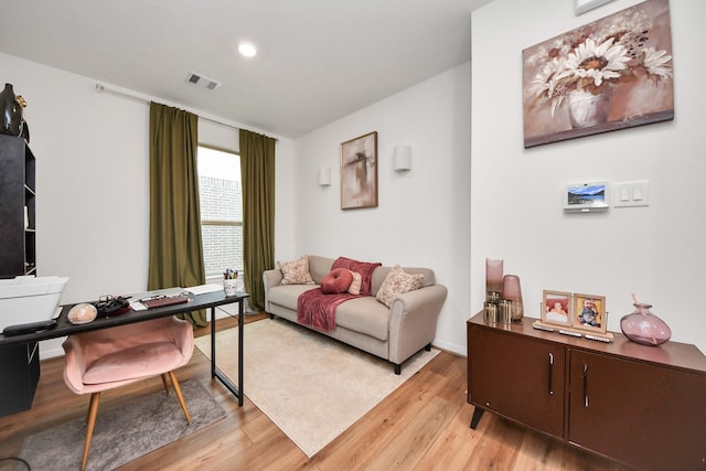 living room featuring visible vents and light wood-style floors