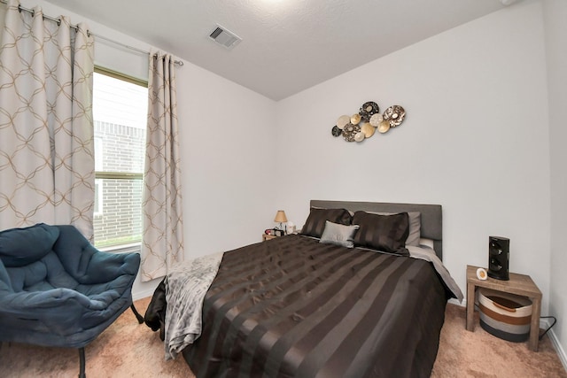 carpeted bedroom with visible vents