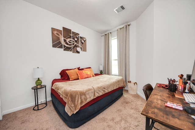 carpeted bedroom featuring visible vents and baseboards