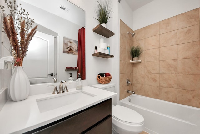 full bathroom with vanity, toilet, washtub / shower combination, and visible vents