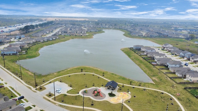 drone / aerial view with a water view and a residential view