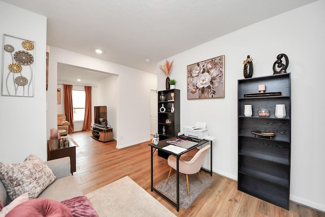 office space featuring recessed lighting, baseboards, and light wood finished floors