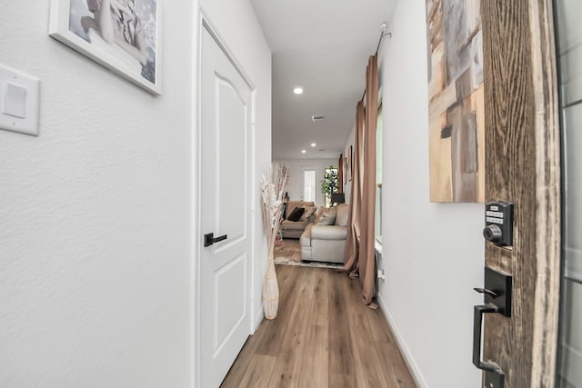 corridor with visible vents, recessed lighting, wood finished floors, and baseboards