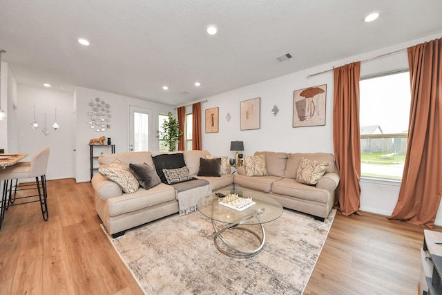 living room with visible vents, recessed lighting, and light wood-style floors