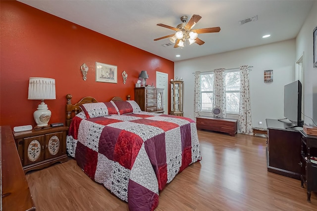 bedroom featuring a ceiling fan, recessed lighting, wood finished floors, and visible vents