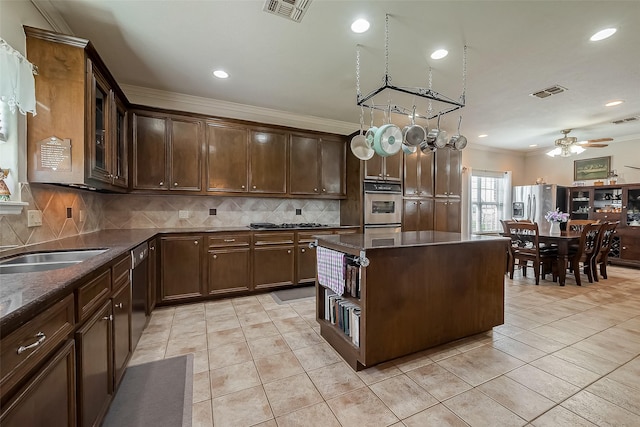 kitchen featuring visible vents, light tile patterned flooring, stainless steel appliances, and ornamental molding