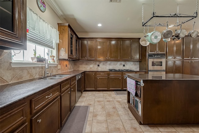 kitchen with a sink, backsplash, stainless steel appliances, light tile patterned floors, and glass insert cabinets