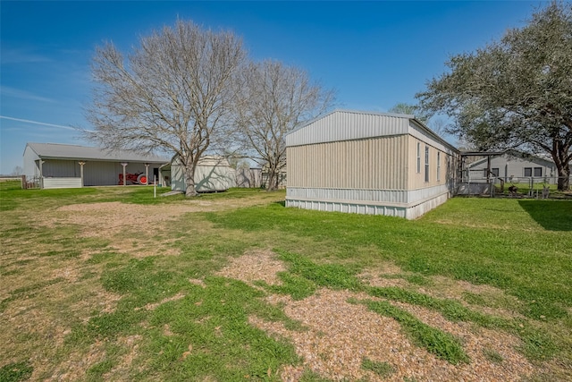 view of yard with an outdoor structure and a pole building