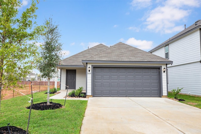 single story home with fence, concrete driveway, a front lawn, and a shingled roof