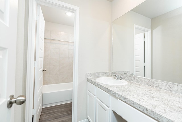 full bath featuring tub / shower combination, wood finished floors, and vanity