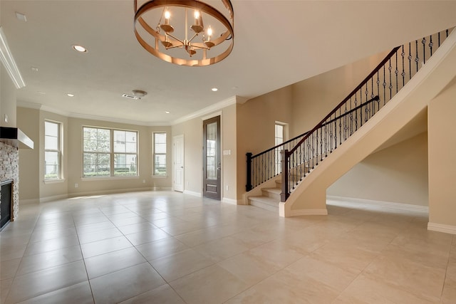 unfurnished living room with stairs, baseboards, a fireplace, and crown molding