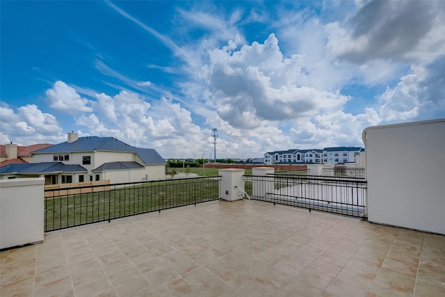 view of patio / terrace with a balcony and a residential view