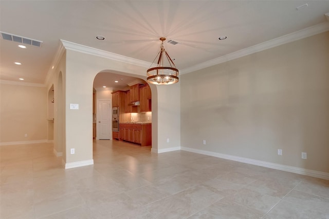 spare room featuring visible vents, baseboards, ornamental molding, recessed lighting, and arched walkways