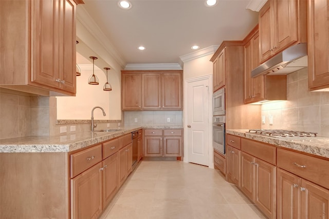 kitchen featuring ornamental molding, under cabinet range hood, a sink, stainless steel appliances, and light stone countertops