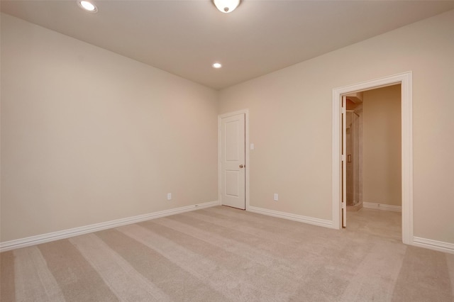 unfurnished room with recessed lighting, light colored carpet, and baseboards