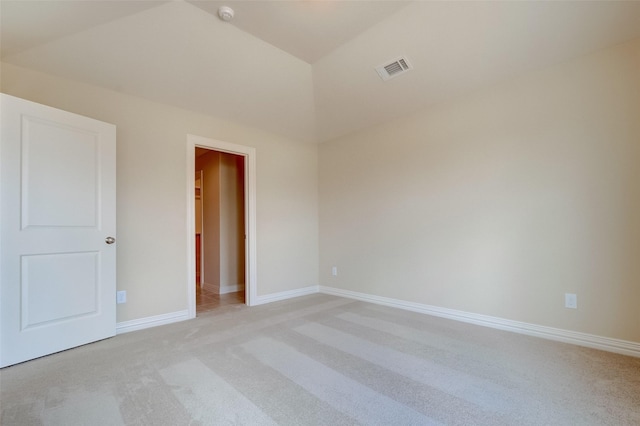 unfurnished room featuring visible vents, baseboards, and light colored carpet