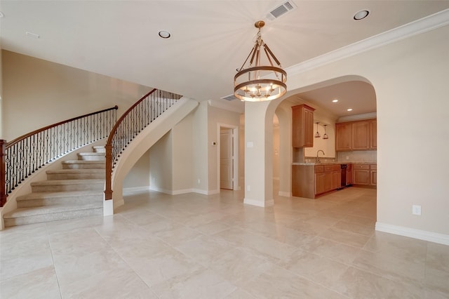 interior space with stairway, visible vents, baseboards, arched walkways, and a notable chandelier