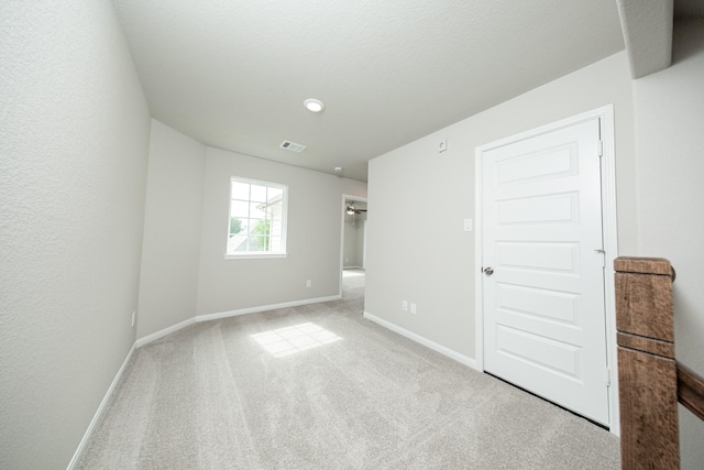 unfurnished bedroom with carpet, baseboards, and visible vents