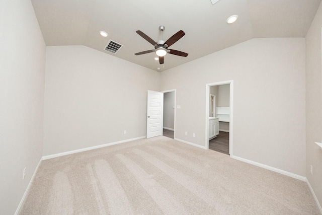 unfurnished bedroom with lofted ceiling, carpet flooring, ensuite bathroom, baseboards, and recessed lighting