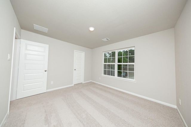 empty room with carpet flooring and baseboards