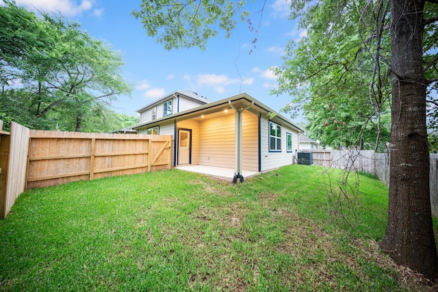 rear view of property with central AC and a patio area
