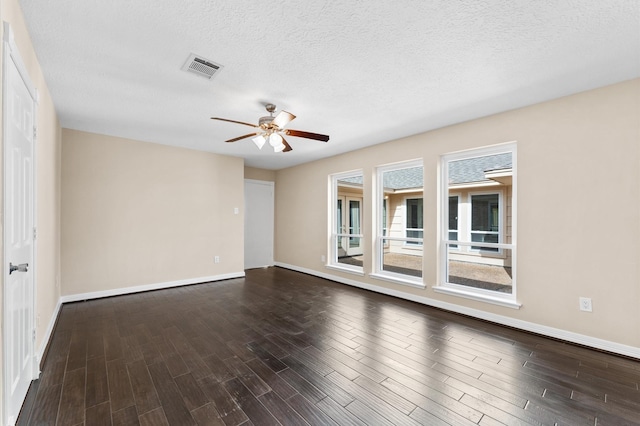 unfurnished room featuring a textured ceiling, baseboards, ceiling fan, and dark wood-style floors