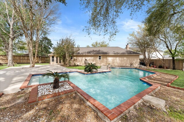 view of pool with a fenced backyard, a patio, a fenced in pool, and french doors